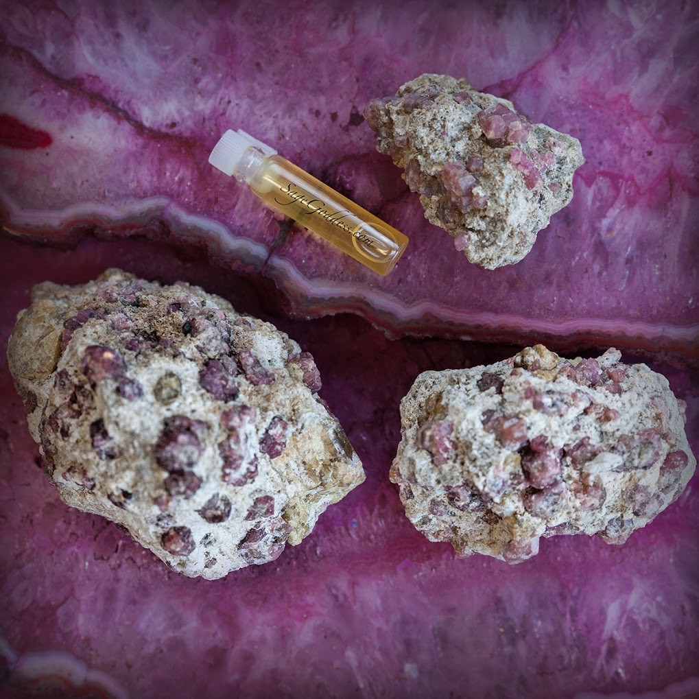 Pink Garnet in Matrix with sample of Revolution Perfume